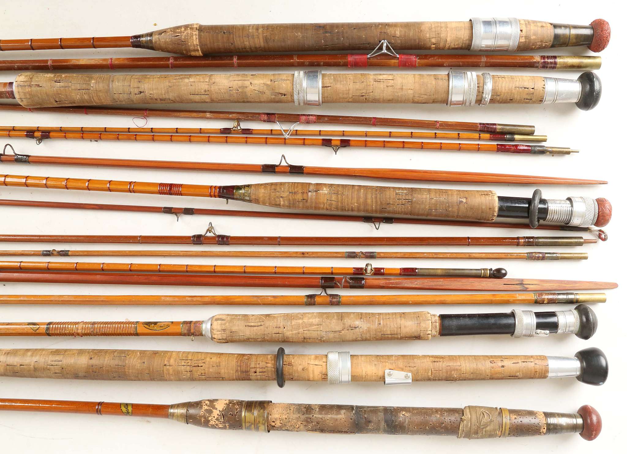A selection of six collectable vintage rods that include a J.S. Sharp split cane three peice fly rod