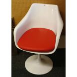 A post modernist moulded white rigid plastic tulip chair, with red cushioned seat