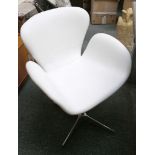 An aviation style aluminium chair with white leather lining