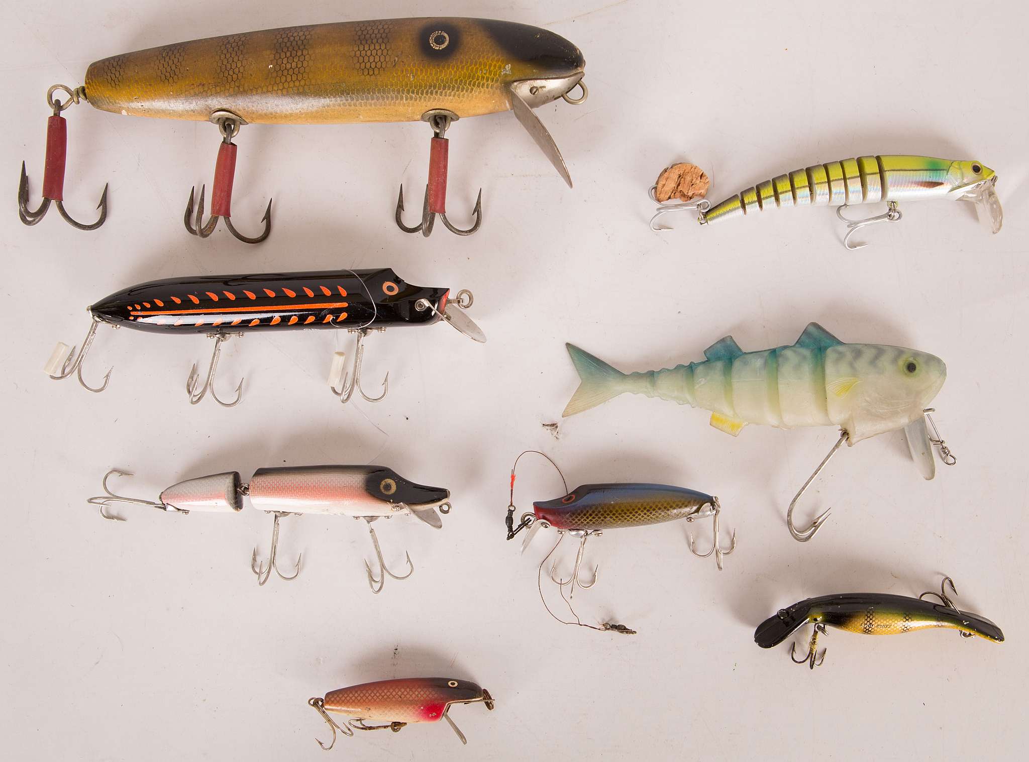 A collection of eight predator 'plug' lures comprising an original Aeddon wood 'vamp' articulated