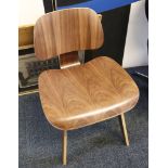 A laminated walnut chair, after a design by Eames