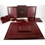 An Asprey gentleman's red Morocco desk set comprising paper and note holder, blotter notebook