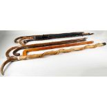 A collection of 20th century walking canes and an Aquascutum umbrella (8)
