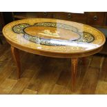 A 1960's Italian coffee table, with marquetry inlaid oval maple top, on cabriole legs, 100 x 58 x