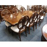 A contemporary walnut effect dining table and chairs, the table with a shaped top with symmetric