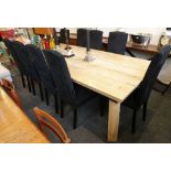 A rough, heavy, rectangular top, dining table, raised on irregular shaped legs, with nine black