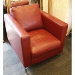 A modern red leather upholstered gun chair, raised on a chrome foot