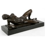 A bronzed model of a recline nude male, inscribed 'Neil' on a black marble base, 30 x 14cm