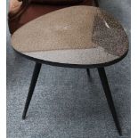 A 1950's occasional table, with triangular laminate top with graphic pattern, on three splayed legs