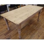 A pine rectangular top kitchen table, raised on turned leg
