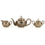 A THREE PIECE CHINESE EXPORT SILVER TEA SET. Circa 1920. Comprised of a teapot and cover, double