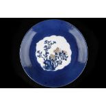 A CHINESE POWDER BLUE CHARGER WITH CENTRAL SCENE. Kangxi. With flowering branches painted in