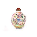 A MOULDED PORCELAIN SNUFF BOTTLE. Late 19th / early 20th Century. Decorated with figures in a