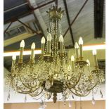 A Georgian style, gilt metal and crystal glass, two tiered chandelier with nine scrolling arms to