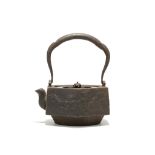 A JAPANESE IRON HEXAGONAL SECTION TETSUBIN KETTLE AND COVER. Edo, 18th / 19th Century. With a