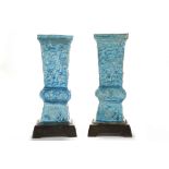 A PAIR OF TURQUOISE GLAZED RECTANGULAR VASES, GU. Qing. With moulded floral and Buddhist emblem