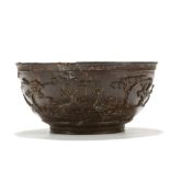 A CHINESE COCONUT WHITE METAL LINED BOWL. Late Qing. The exterior finely carved with a continuous