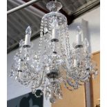 An eight branch, cut glass chandelier, the stem is 'hobnail' cut decorated, and garlands of drops