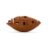 A CHINESE BRAZIL NUT CARVED IN THE FORM OF A MINIATURE BOAT. Early 20th Century. The bottom