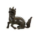 A CHINESE BRONZE  BUDDHIST LION DOG CENSER. Ming. Cast seated with the front left paw cocked back,