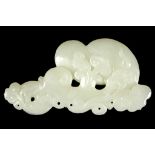 A CHINESE JADE PENDANT FORMED AS A LINGZHI SPRAY. Qing Dynasty. Deeply carved with various