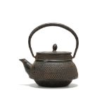 A JAPANESE IRON TETSUBIN KETTLE AND COVER. 20th Century. With sloping shoulders the body covered