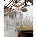 An eight branch, cut glass chandelier with baluster stem, and festooned with garlands of glass