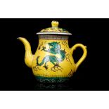 A CHINESE YELLOW GROUND DRAGON TEAPOT AND COVER. Republican era. Potted in pear-shaped form, the