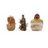 THREE AGATE SNUFF BOTTLES. Late 19th / early 20th Century. The first two carved with leafy