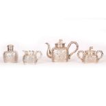 A CHINESE SILVER FOUR PIECE TEA SERVICE. c. 1900. Comprising a teapot, double handled sugar bowl,