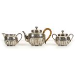 A THREE PIECE JAPANESE SILVER TEASET. Miyamoto Shoko, Tokyo. Comprised of a teapot and cover, double