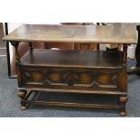 A 1920's oak monk's bench, geometric decoration to back rest, scroll arms, lift up seat, further