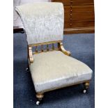 A Victorian giltwood low chair on turned legs