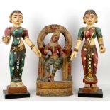 Three Indian polychrome wood figures, including two female figures, 43cm high; and a shrine to the