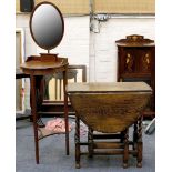 An Edwardian mahogany gentleman's vanity stand, oval mirror over 'D' brush rest, lower tier,