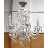 A pair of five branch crystal glass chandeliers, with baluster and knop stem, festooned with buttons