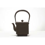 A JAPANESE IRON SQUARE SECTION TETSUBIN KETTLE AND COVER. 19th Century. Of cuboidal form, raised