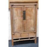 A stripped Chinese pine and fruitwood cabinet, probably 19th Century, on square section legs