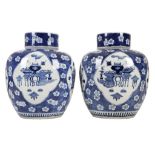 A PAIR OF BLUE AND WHITE GINGER JARS AND COVERS. Late 19th / early 20th Century. Decorated with bagu