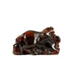 A CHINESE AMBER CARVING OF A DEER. 17th Century. Seated with the legs tucked under, the head