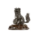 A CHINESE BRONZE BUDDHIST LION DOG CENSER. Late Ming. Cast seated in an upright position, with the