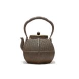 A JAPANESE IRON HEXAGONAL BASKET WEAVE EFFECT TETSUBIN KETTLE AND COVER. 19th Century. The body