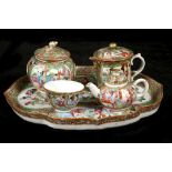 A CHINESE CANTON FAMILLE ROSE FOUR PIECE TEA SERVICE AND TRAY. Late Qing, 19th Century. Comprising a