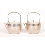 A PAIR OF JAPANESE TINWARE KETTLES. 20th Century. Of cylindrical section with a rounded foot, with