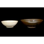 TWO CHINESE BOWLS. Song. One covered in a whitish-cream glaze, 11cm diameter, the other with a