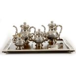 A VIETNAMESE SILVER SIX PIECE TEASET. Early 20th Century. Comprising a teapot, coffeepot, sugar pot,