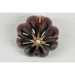 A Victorian high ct gold mounted carved garnet brooch, with centred pearl