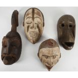 African tribal art, four wood masks, including a Dan Kran mask, a Bete mask, a Yombe mask and an