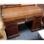 A good Edwardian Warings mahogany tambour topped d