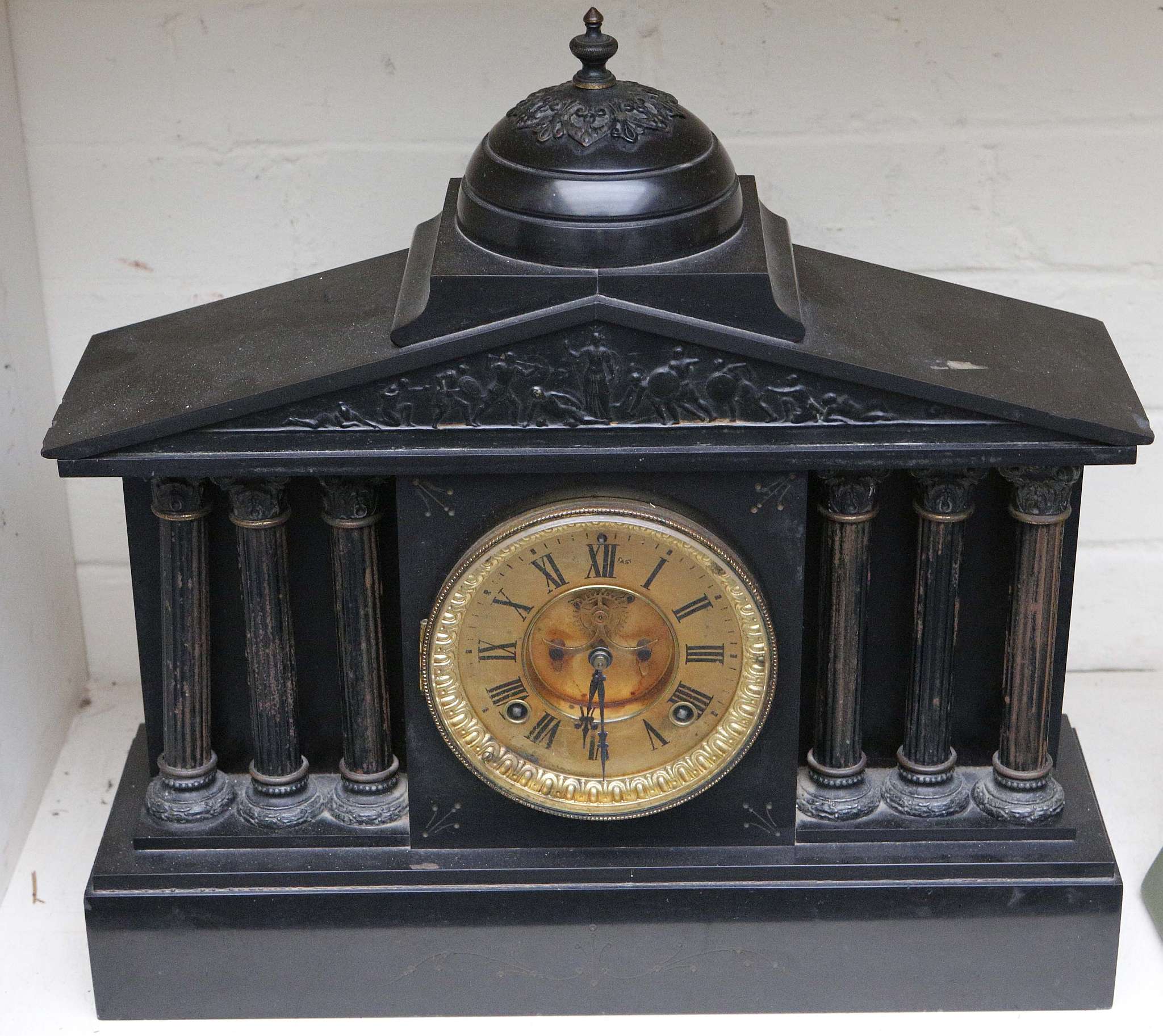A large Victorian black marble mantel clock